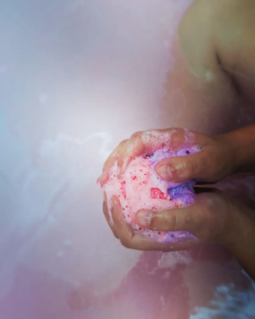 A child holding a fizzing bath bomb
