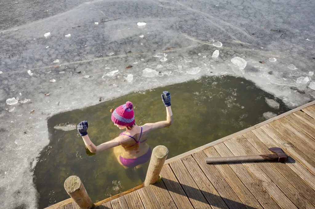 A woman taking a cold plunge.