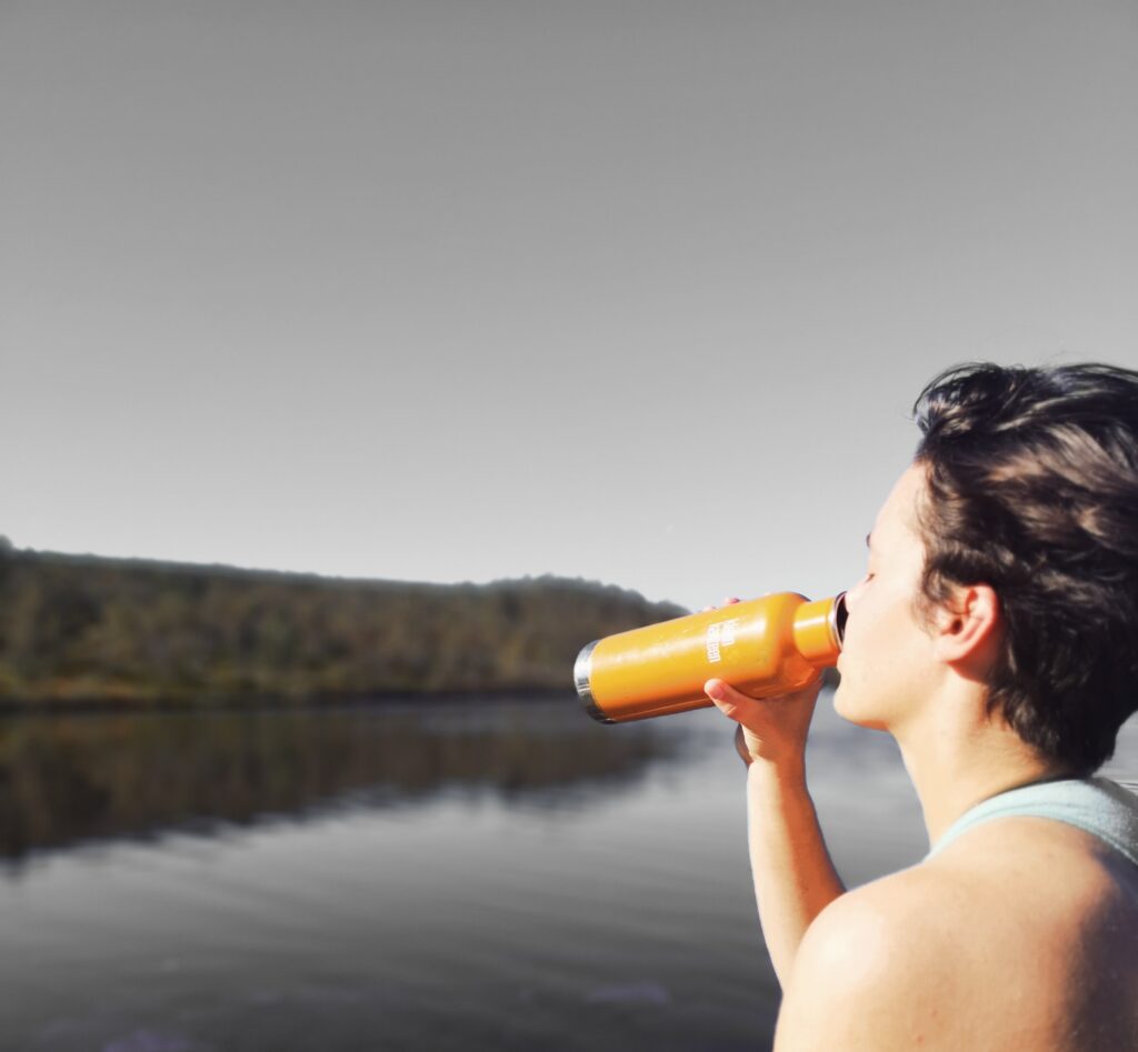 A middle aged woman drinking water