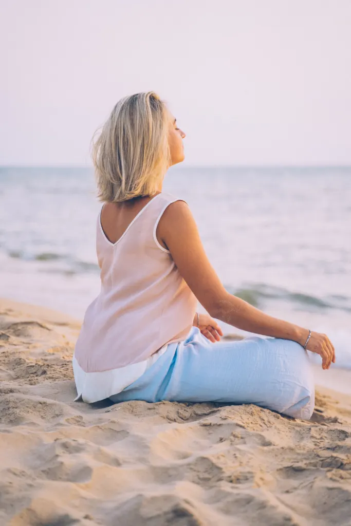 A woman meditating - How to Handle Cravings When Detoxing